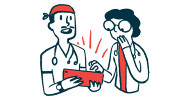 Two doctors look at a tablet.