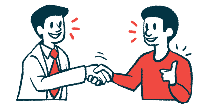 A doctor shakes hands with a patient who is making a thumbs-up gesture.