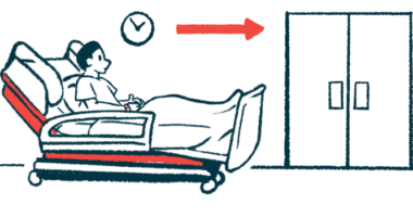 A patient sits in a hospital bed in a hallway near a set of closed double doors.